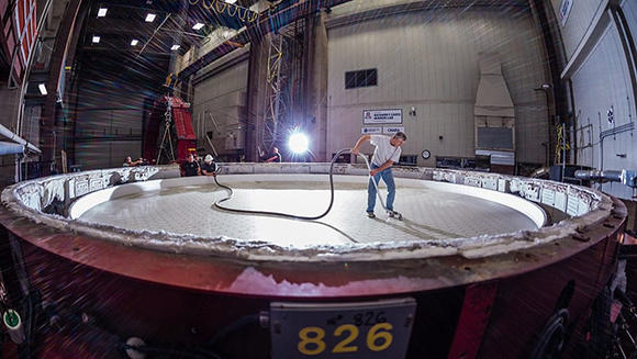 עשרים טונות של זכוכית. מנהל היציקה רנדי לוץ (Lutz) מאוניברסיטת אריזונה מנקה את מראה מספר 5 של הטלסקופ | צילום: GMTO Corporation