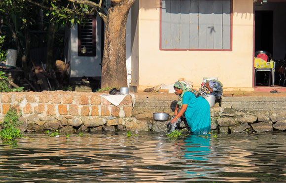  A woman doing laundry in the river in India, 2015 | Photography: Just Another Photographer, Shutterstock